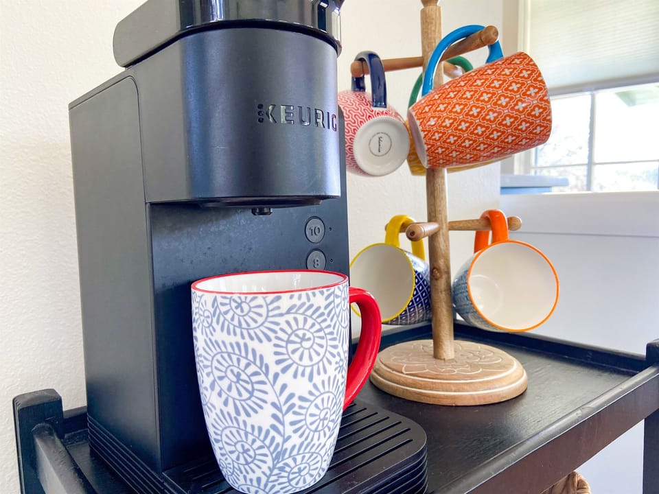 Keurig coffee maker, coffee, sweetener & creamer