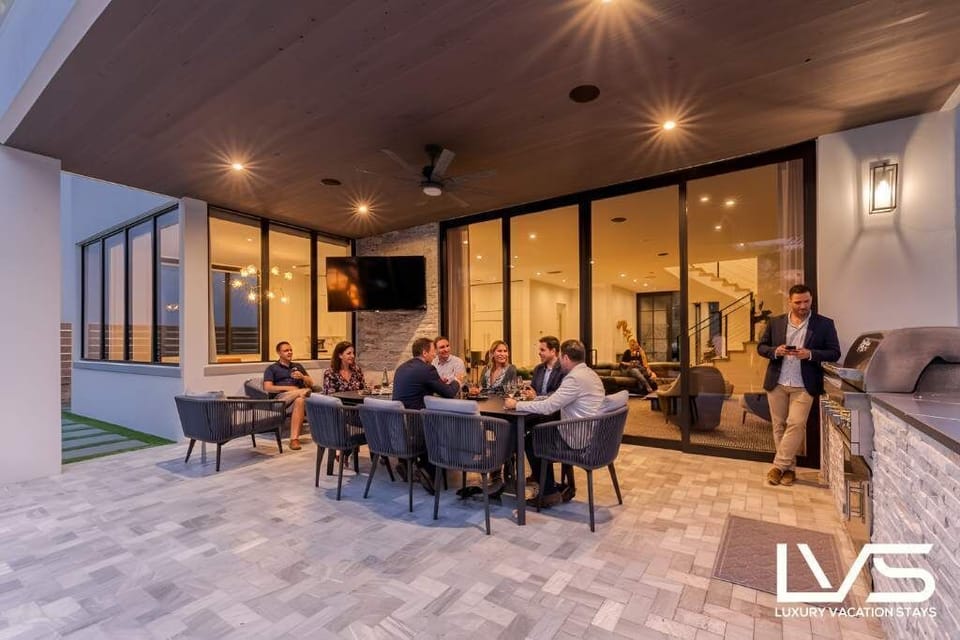 Stunning outdoor space with outdoor TV, Sonos Surround Sound, Built in BBQ, Heated LUXE Pool, Outdoor Dining & More!!