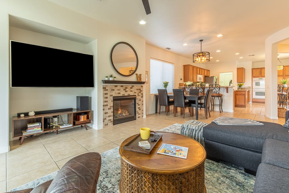 Living Room with large tv, gas fireplace and dining room