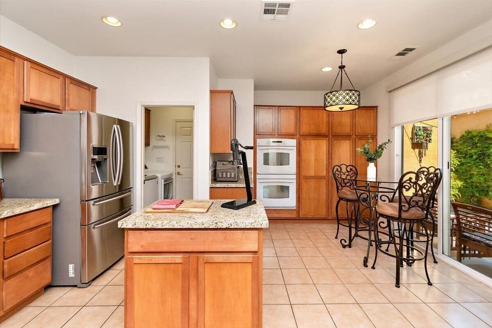 Kitchen with seating, double oven, air fryer, entrance to laundry room