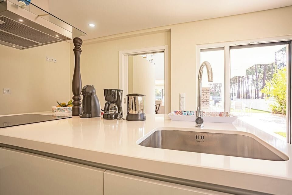 Modern kitchen with white countertops and stainless steel sink — Villa Sassi, holiday villa in Aroeira