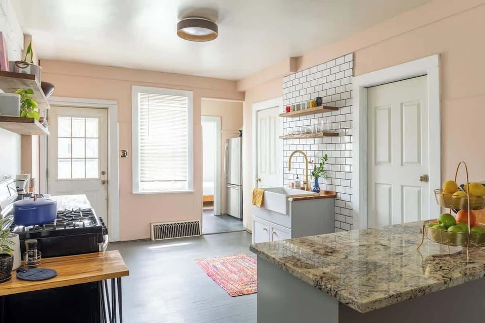 Granite island, subway tile, and a huge and beautiful farmhouse sink.