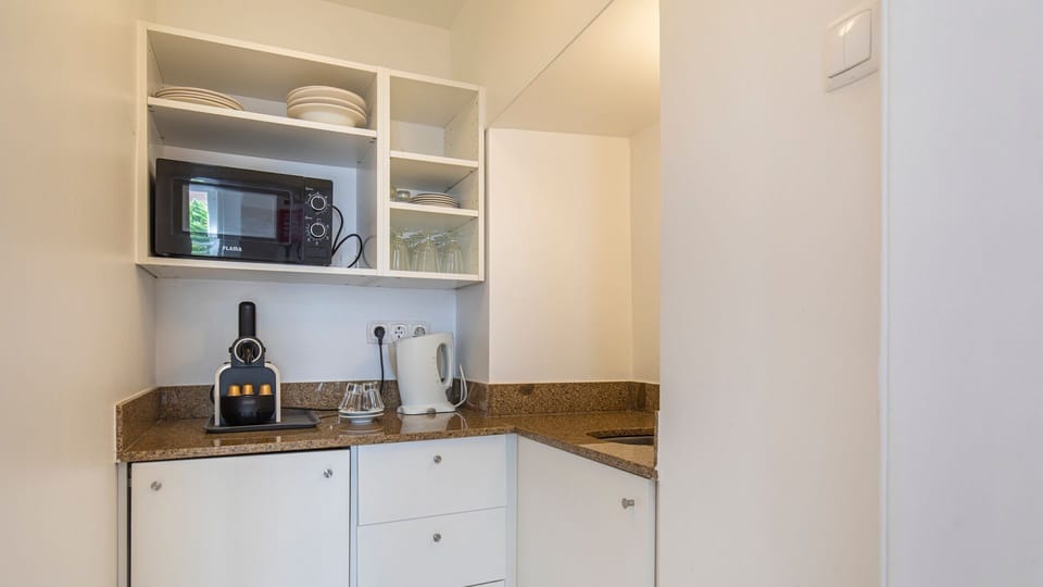 Very handy kitchenette with a dishwasher, microwave, mini fridge, coffee machine, stove and cooking utensils. #kitchen #cooking