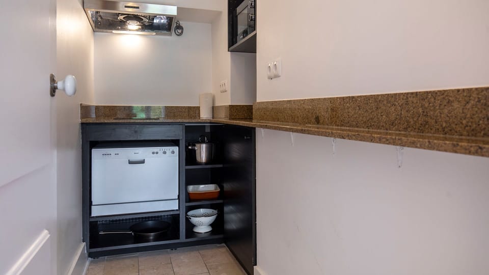 Very handy kitchenette with a dishwasher, microwave, mini fridge, coffee machine, stove and cooking utensils. #kitchen #cooking