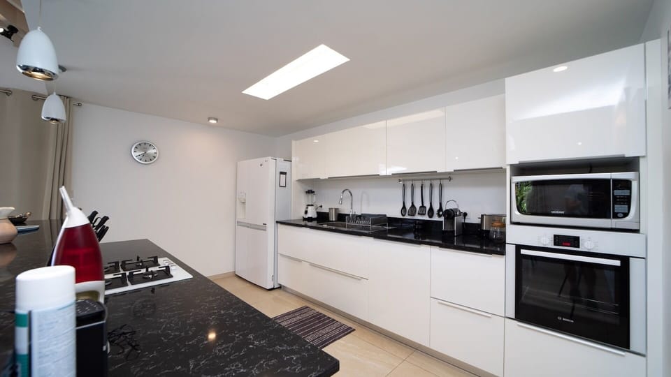 Kitchen: Air-conditioned kitchen equipped with electric oven, gas stove, microwave, fridge and freez