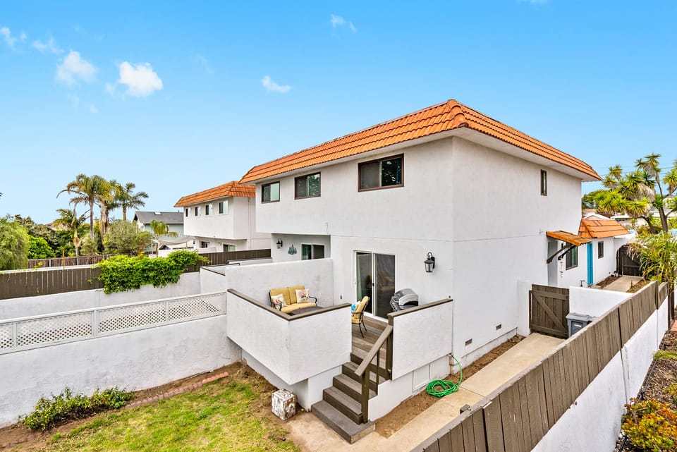 Pictured is the private fenced backyard and patio.