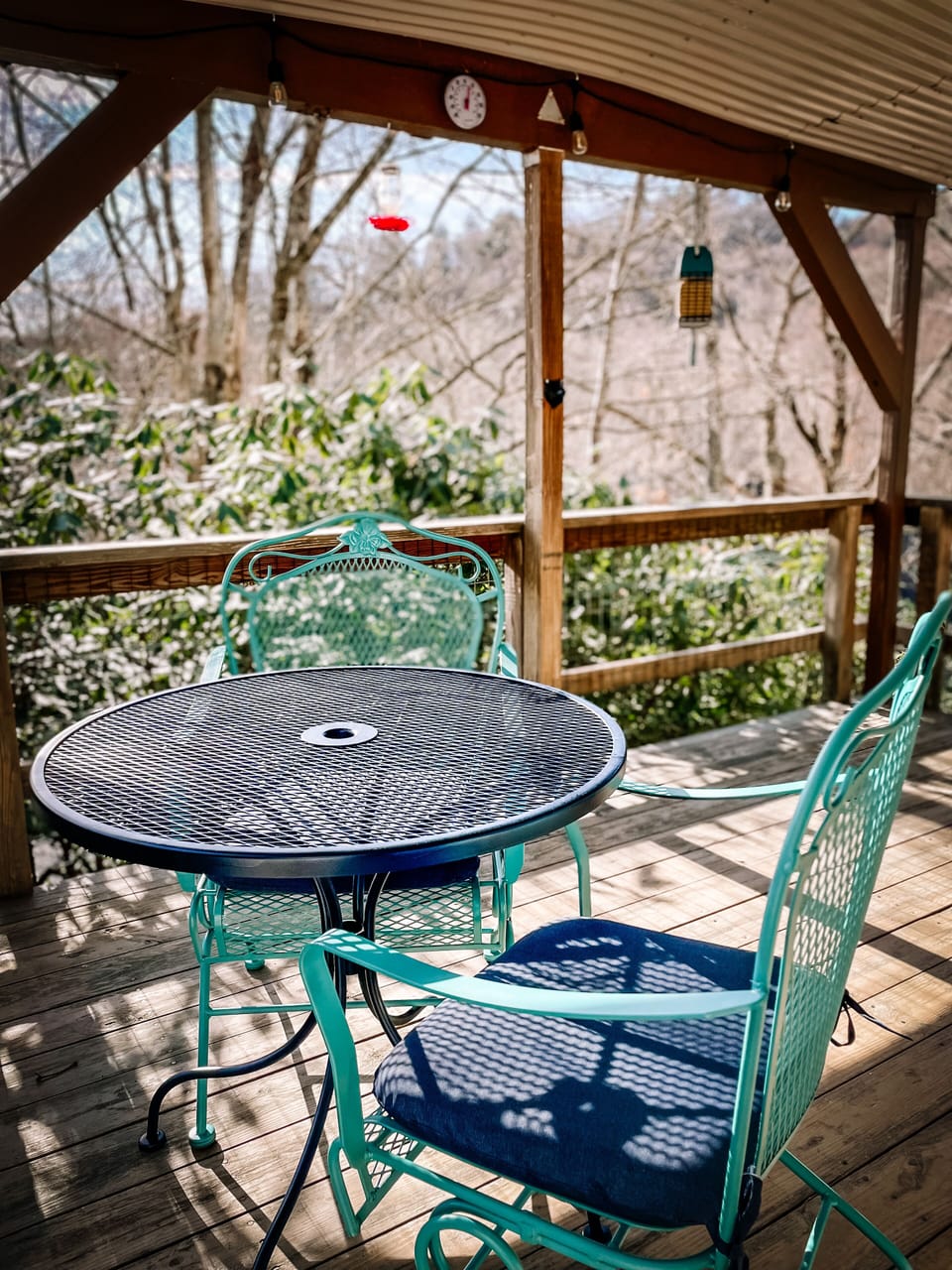 The patio has a seating area for four with a seasonal view