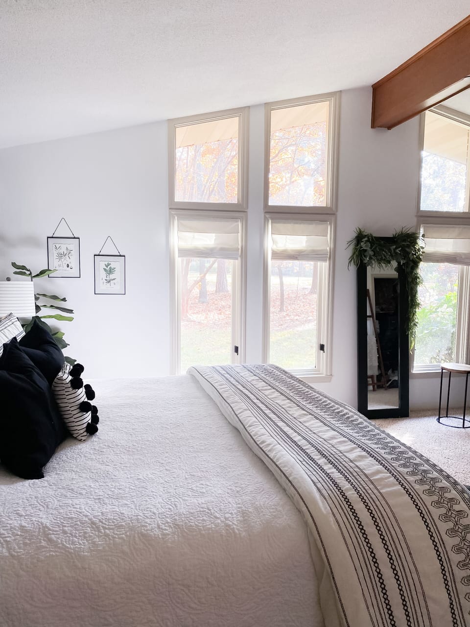 master includes large windows with views of the flower filled yard