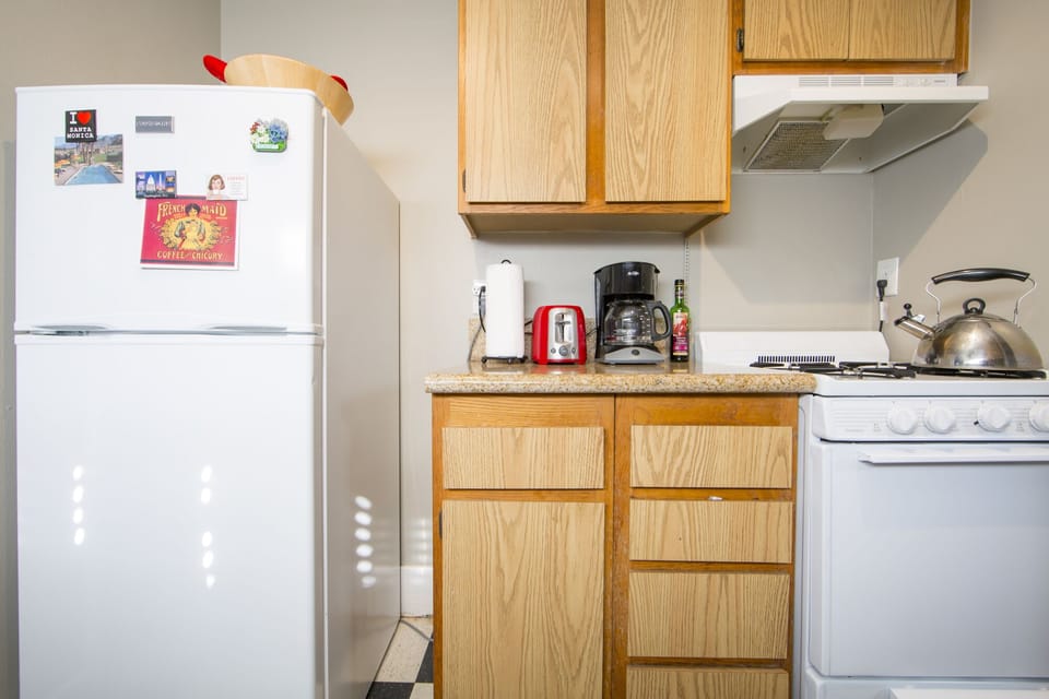 Four burners gas stove and oven, coffee machine, toaster, refrigerator.