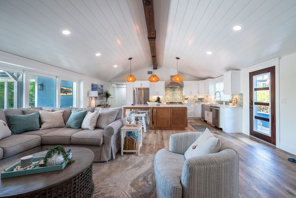 Great room and kitchen.  Wood beams with ship lap ceiling. 