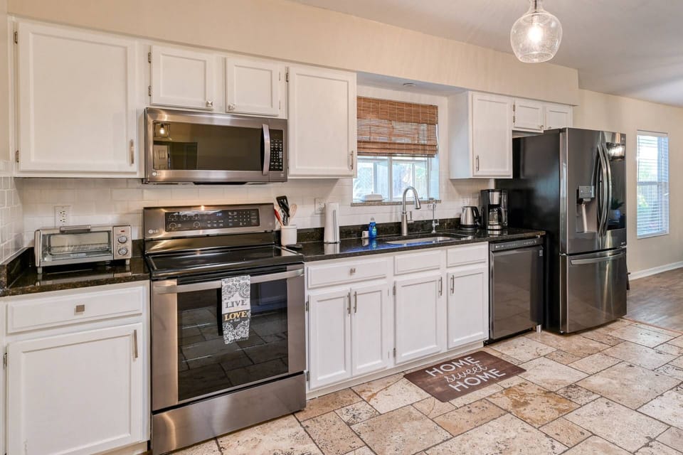 This updated kitchen features all stainless steel appliances, and is well-stocked for all your cooking needs!