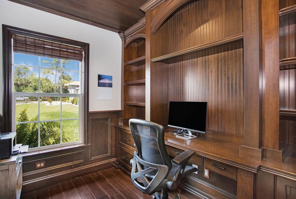 Office with a monitor, wifi and color printer. French doors for privacy.