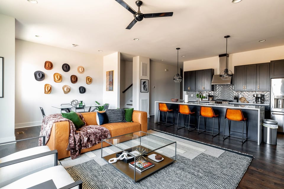 2nd Floor: Bright and open living room featuring a Smart TV,  Designer Furnishings and a dining room that seats 6 guests.