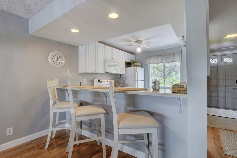 The Kitchen Has a Bar and Stools