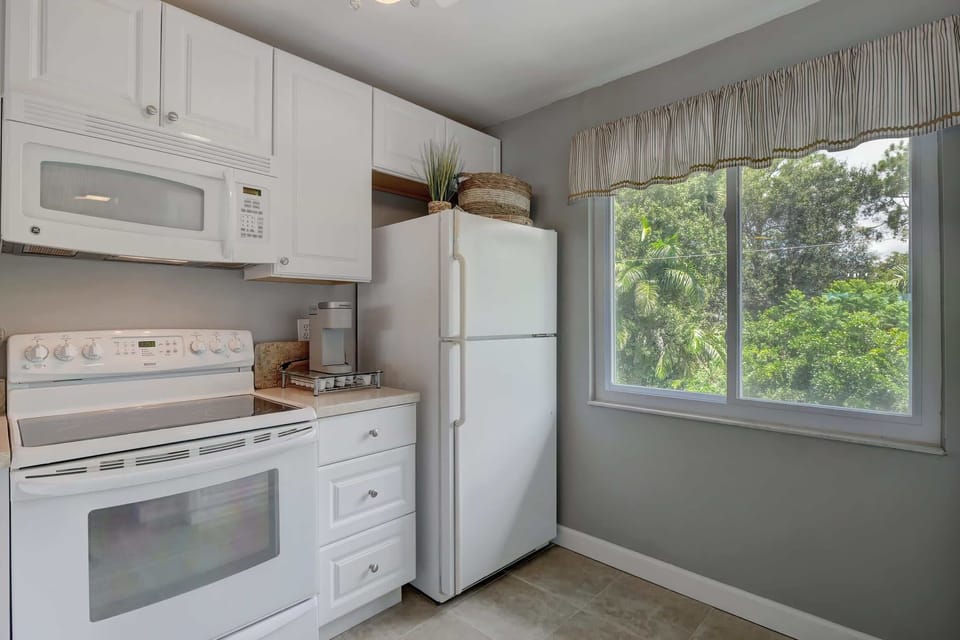 The Kitchen Has a Large Window Letting in Lots of Natural Light