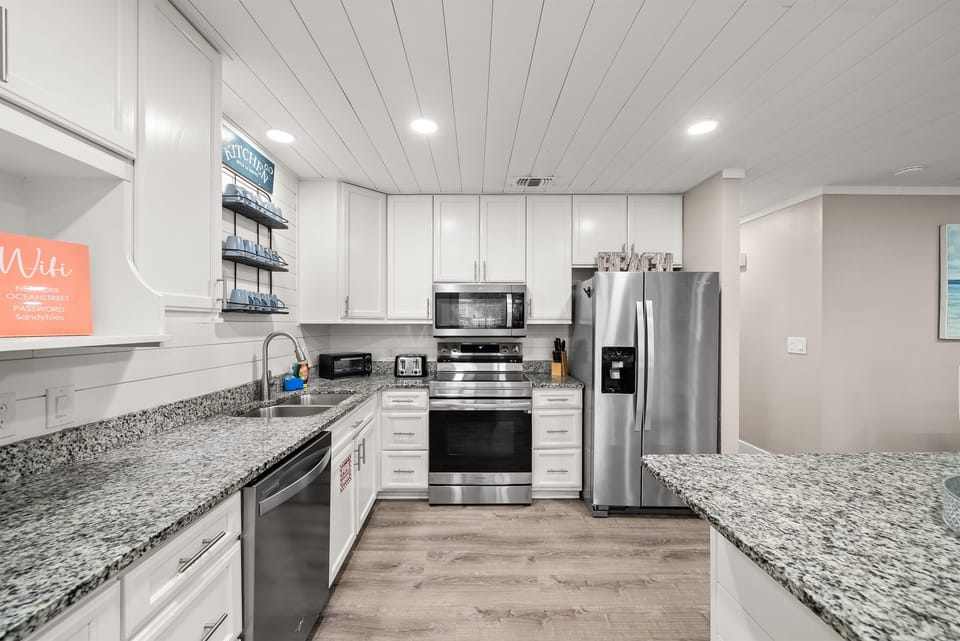 Primary kitchen boasts granite countertops, stainless steel refrigerator/freezer, and plenty of cookware to prepare meals for large parties. We have place settings for 20.