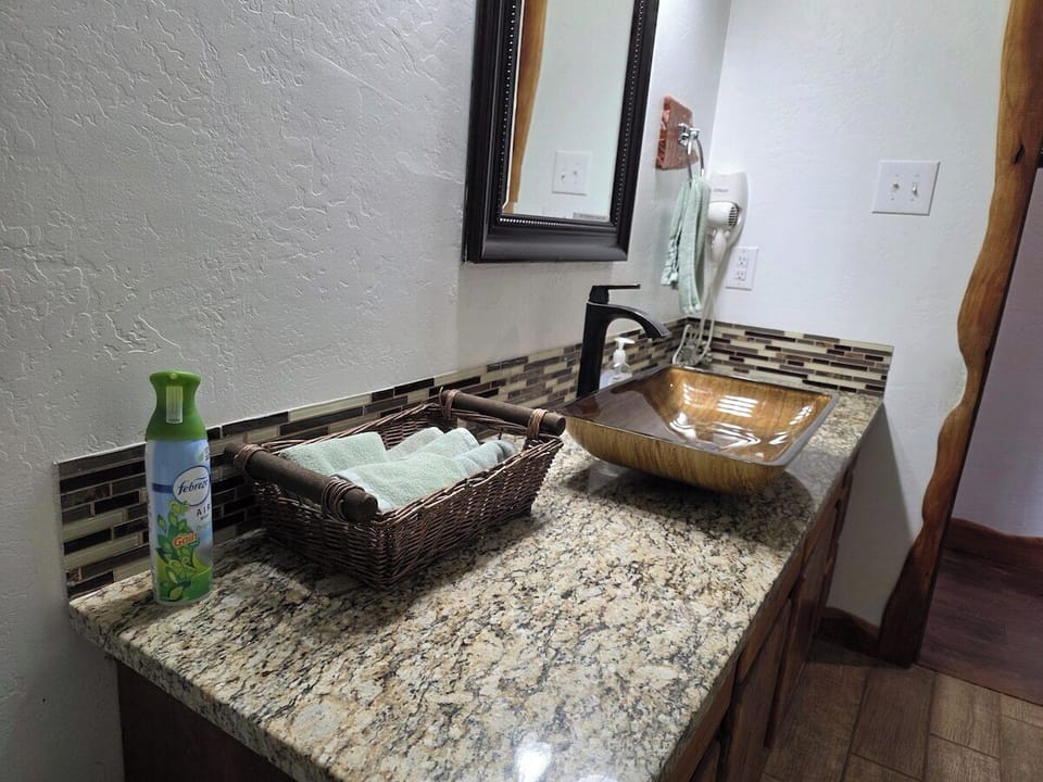 Glass vessel sink on granite.