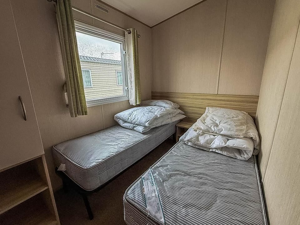 Cozy twin bedroom with natural light and storage space