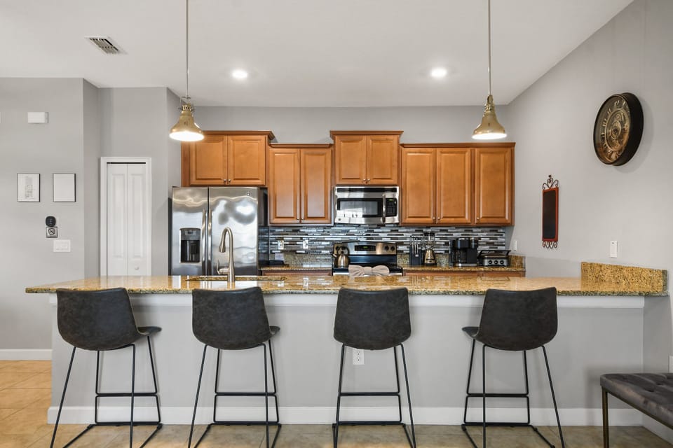 The kitchen has an oversized counter for preparing and serving meals.