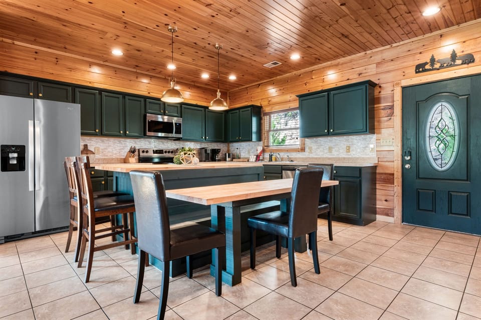There's space for everyone to enjoy meals. The island seats 7 and an additional 8 spaces at the dining table.
