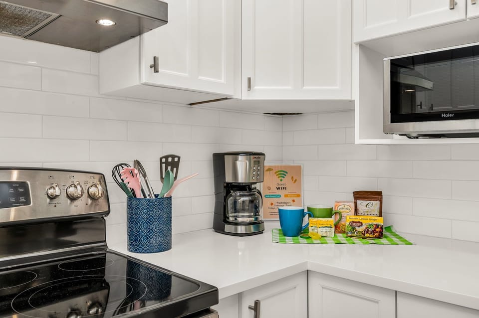 The luminous, fully-equipped kitchen serves as a culinary haven, perfect for post-beach gatherings or sunset cookouts. It's thoughtfully stocked with all the essentials for cooking, whether you're dining indoors or outdoors.
