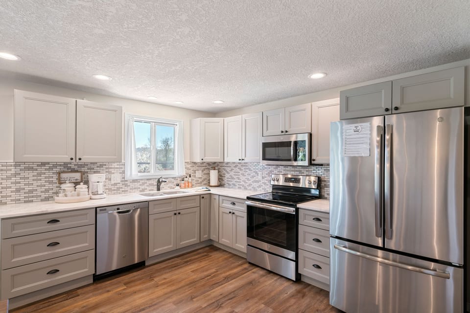 The kitchen is fully stocked with all cookware, dishes and utensils needed.