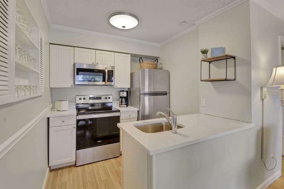 Kitchen - New appliances and countertops in this open, bright, white kitchen