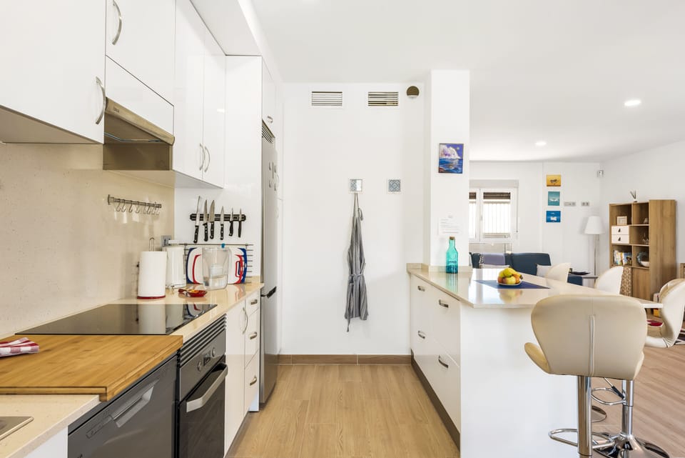 Kitchen island view from behind - full equipped kitchen