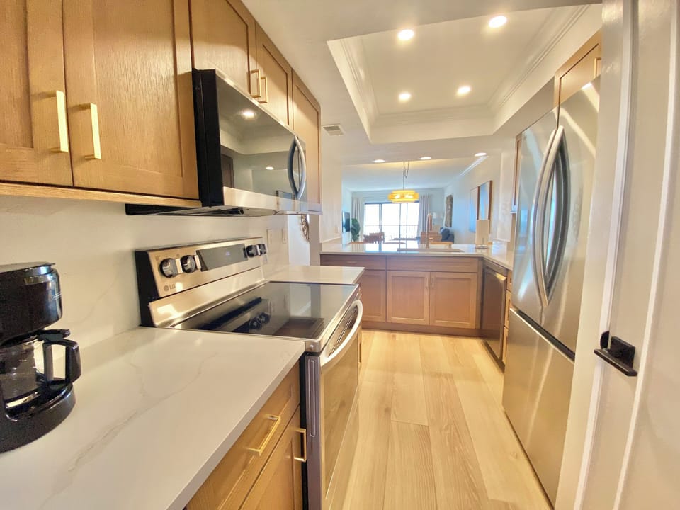 The bright, pristine kitchen has everything you need to cook a delicious meal