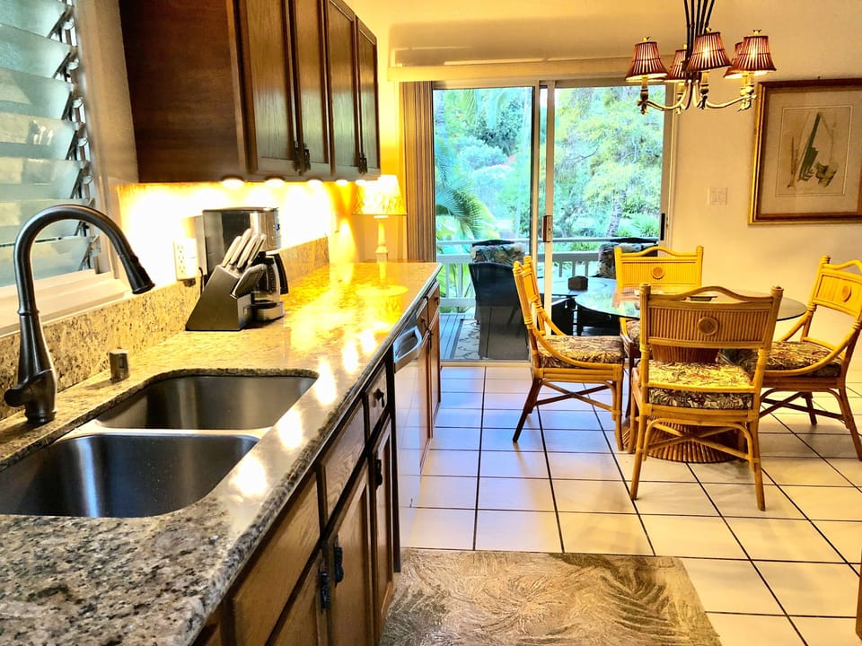 Well-stocked kitchen with marble countertop, AC and ceiling fan