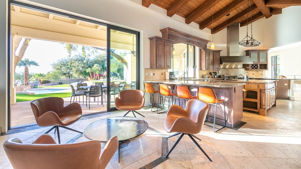 Spacious open-plan living area with modern kitchen and seamless outdoor flow.