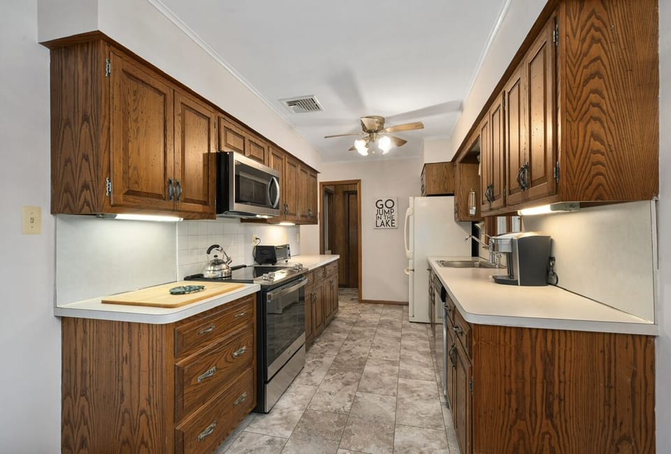 Full kitchen with updated stainless steel appliances.