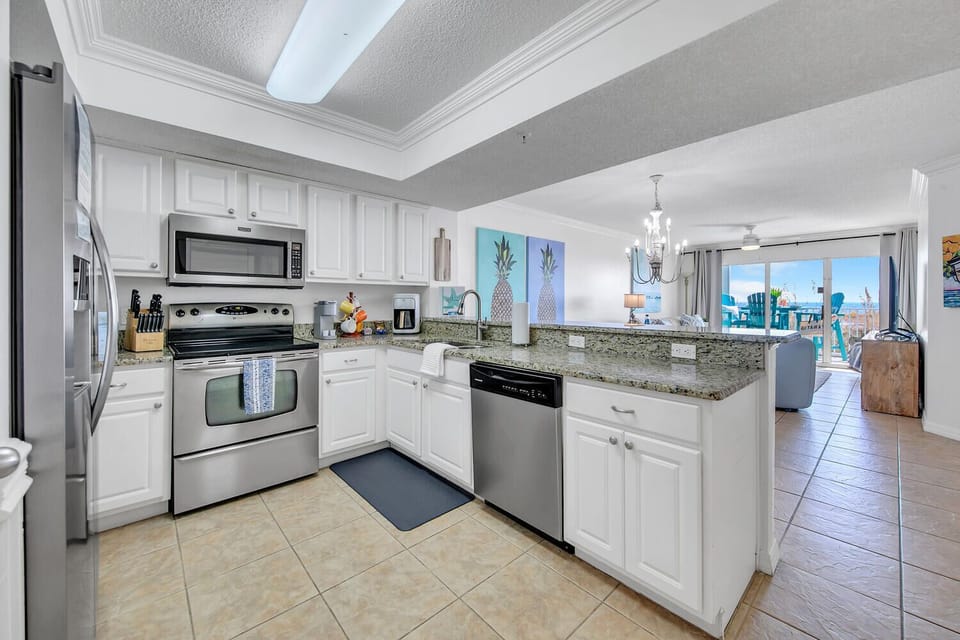Your fully equipped kitchen offers granite counters, stainless appliances, and an open layout perfect for preparing meals while staying connected to the living area.