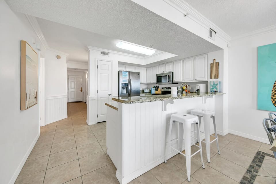 Your bright, open kitchen invites you to prepare meals with granite counters, white cabinets, and a convenient breakfast bar for casual dining.