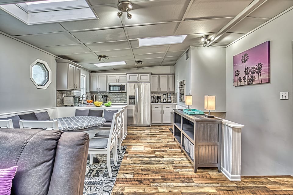 The updated kitchen is fully stocked with everything you need: stainless appliances, dishwasher, and even extras like crockpot, blender, and Keurig. The kitchen is open to breakfast area and family room with a huge TV.