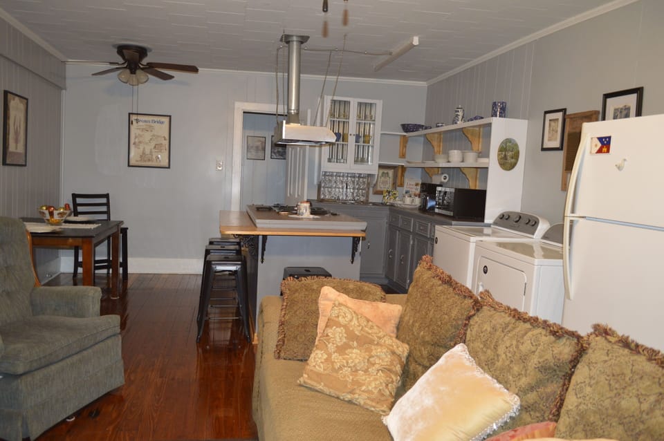 View of the kitchen, bar, appliances, and dinner table.