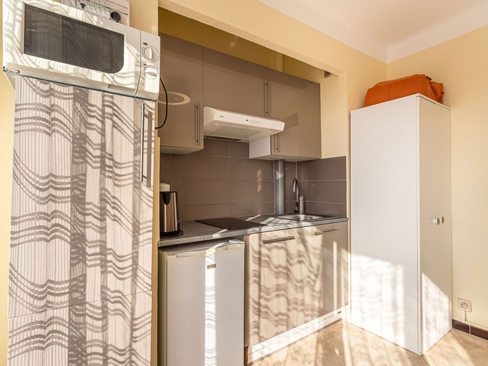 Wood, Interior Design, Floor, Flooring, Major Appliance, Furniture, Room, Cabinetry, Apartment, Kitchen