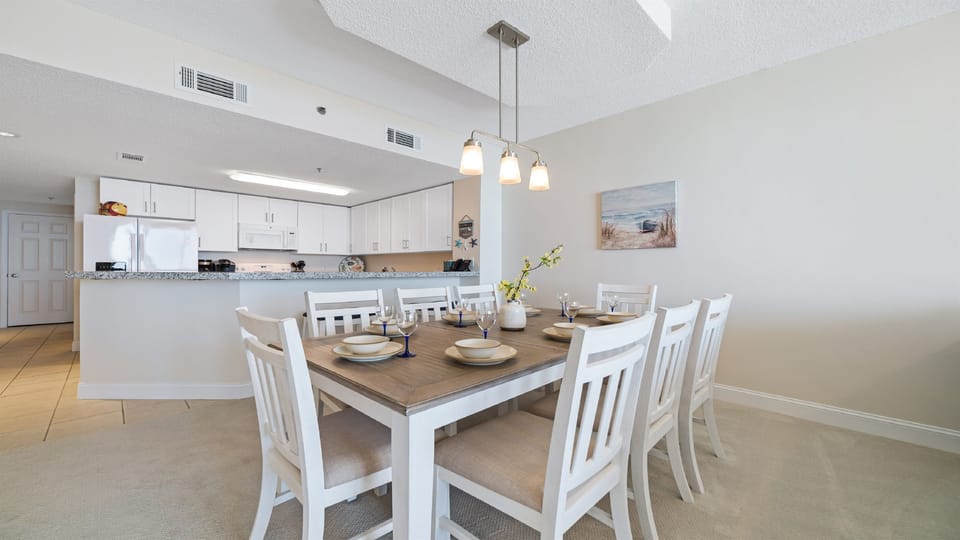 Flexible dining options for every occasion. Enjoy a formal meal at the dining table or a casual snack at the breakfast bar, seamlessly connected to the fully equipped kitchen.