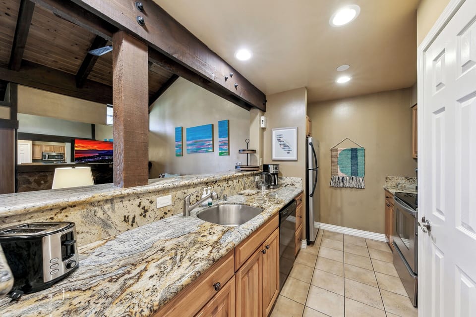 Your granite counters and exposed beams create rustic charm while modern appliances ensure comfort for home-cooked meals.