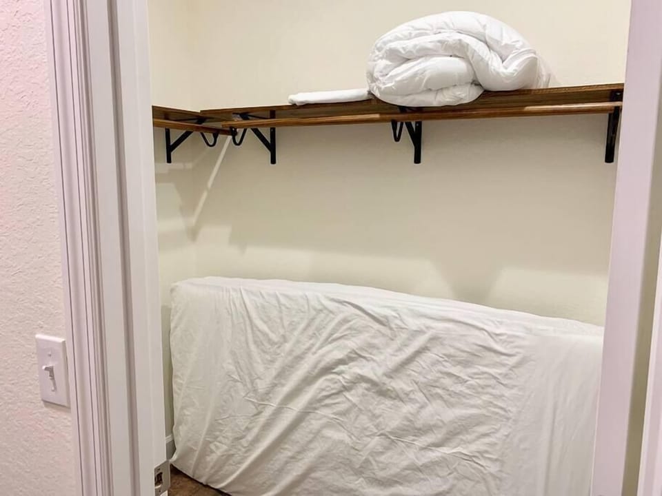 Extra comfy twin mattress and bedding in master closet. 