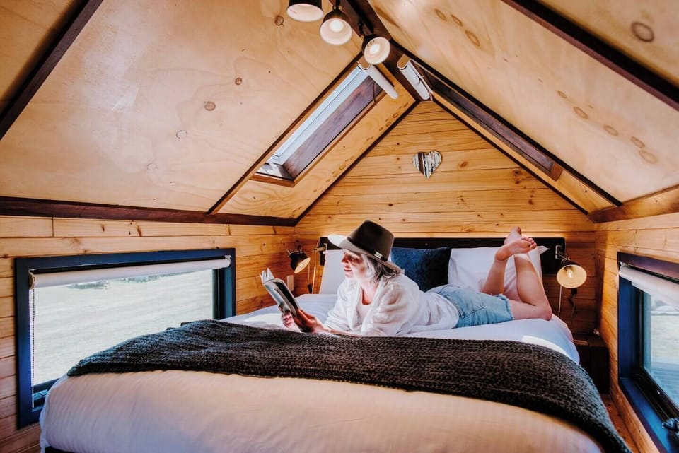 The bedroom area features a sumptuous queen-size bed and skylight above to see the stars at night.
