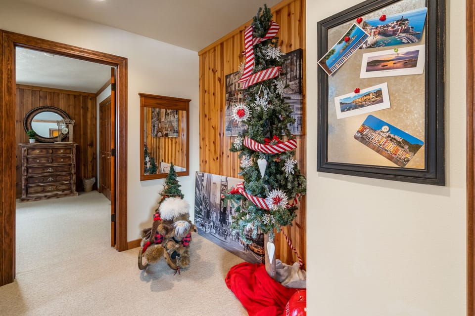 Upstairs hallway with two bedrooms and one bathroom.