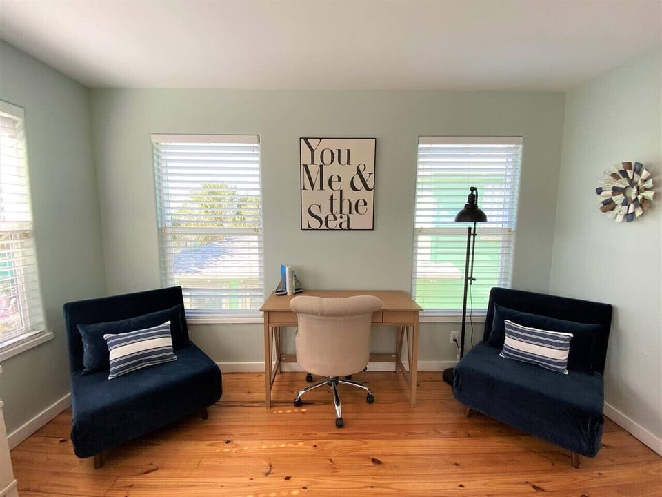 Bright workspace with twin sleeper chairs — ideal for remote work or extra guests.