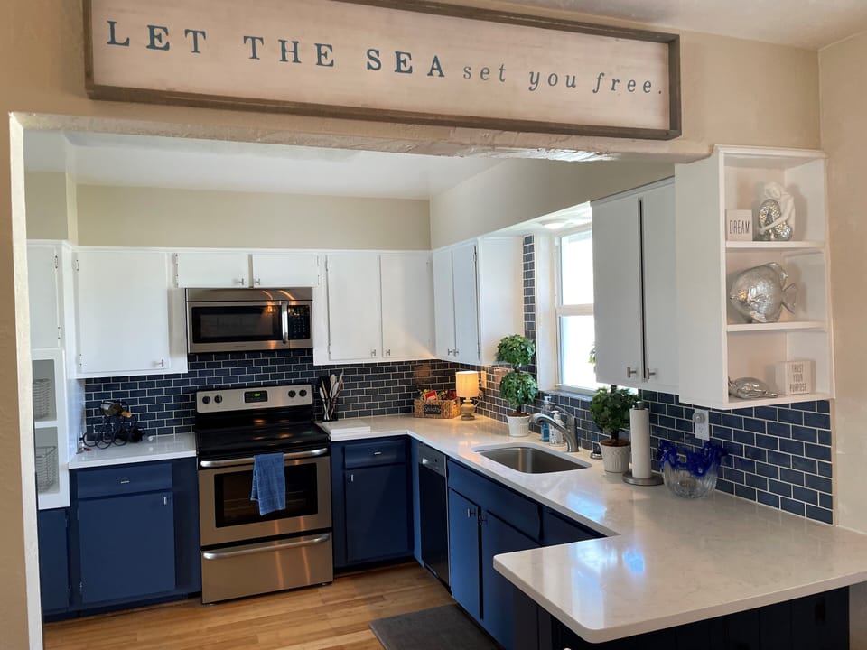 fully stocked kitchen with dishes, utensils and cookware