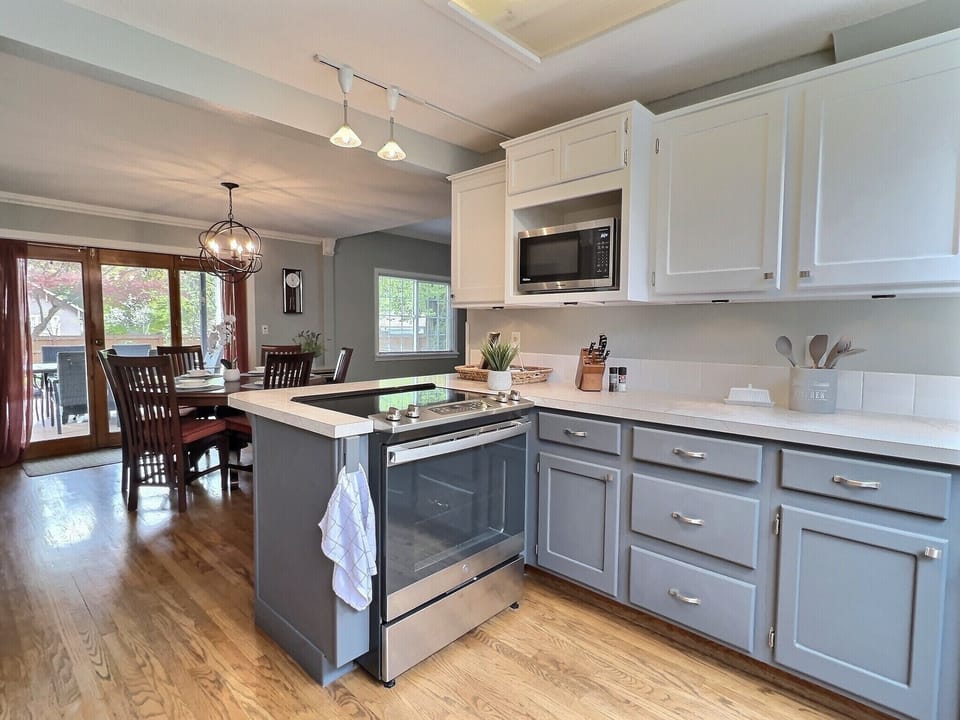 Mix cocktails in bright large kitchen with views of the yard. 