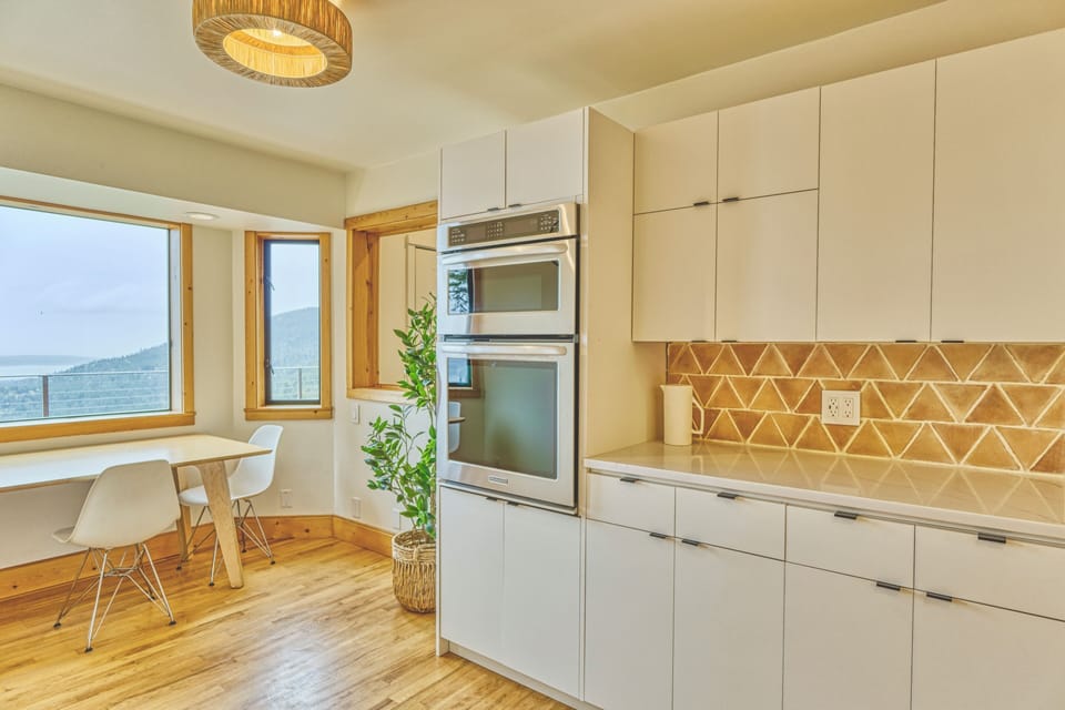 Newly remodeled kitchen with oven, microwave, and breakfast nook