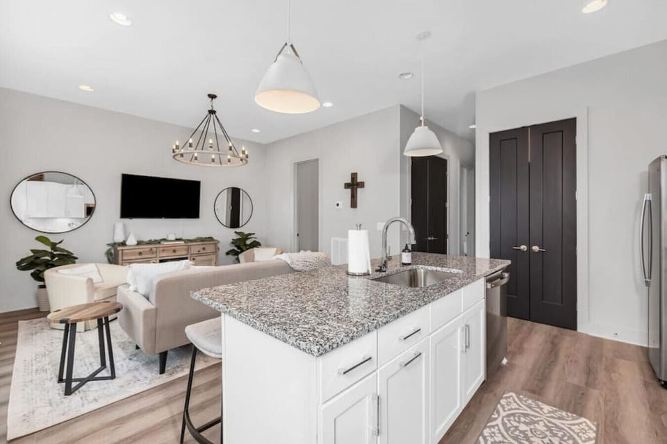 Kitchen with island stocked with pots, pans, and utensils