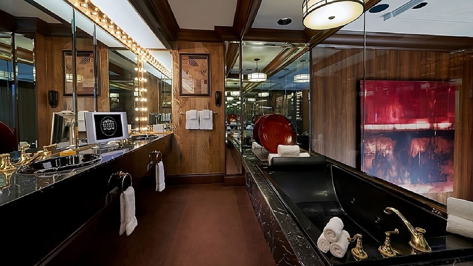 Indulge in a spa-like soak with dramatic mirror reflections.