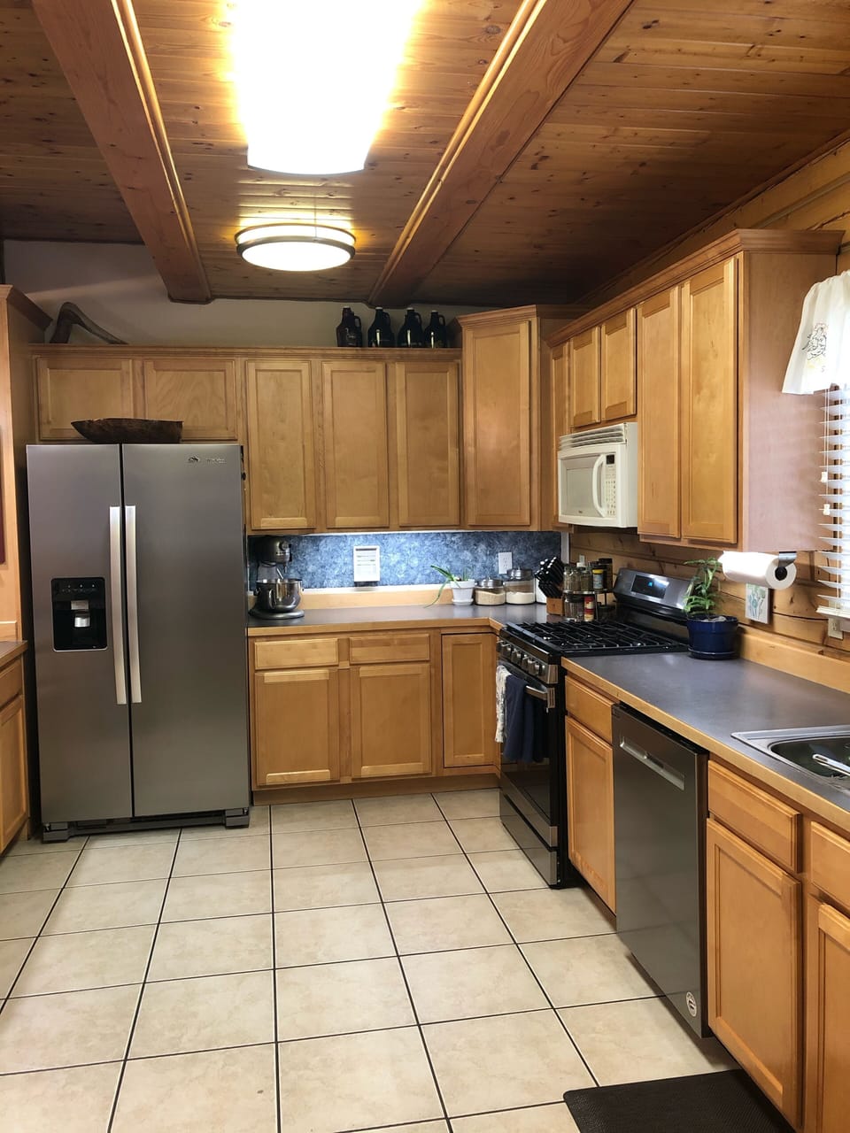 Huge kitchen with many small appliances, spices, and utensils