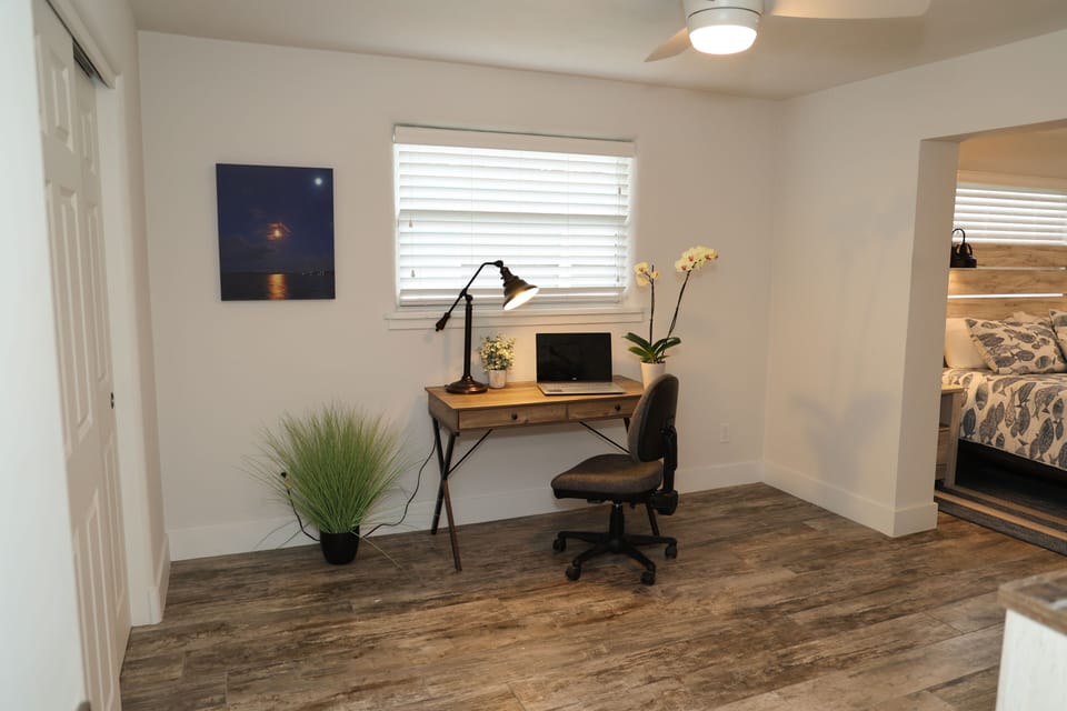 Work area supplied with chargers, outlets and quick Wi-Fi.  Two desk chairs 